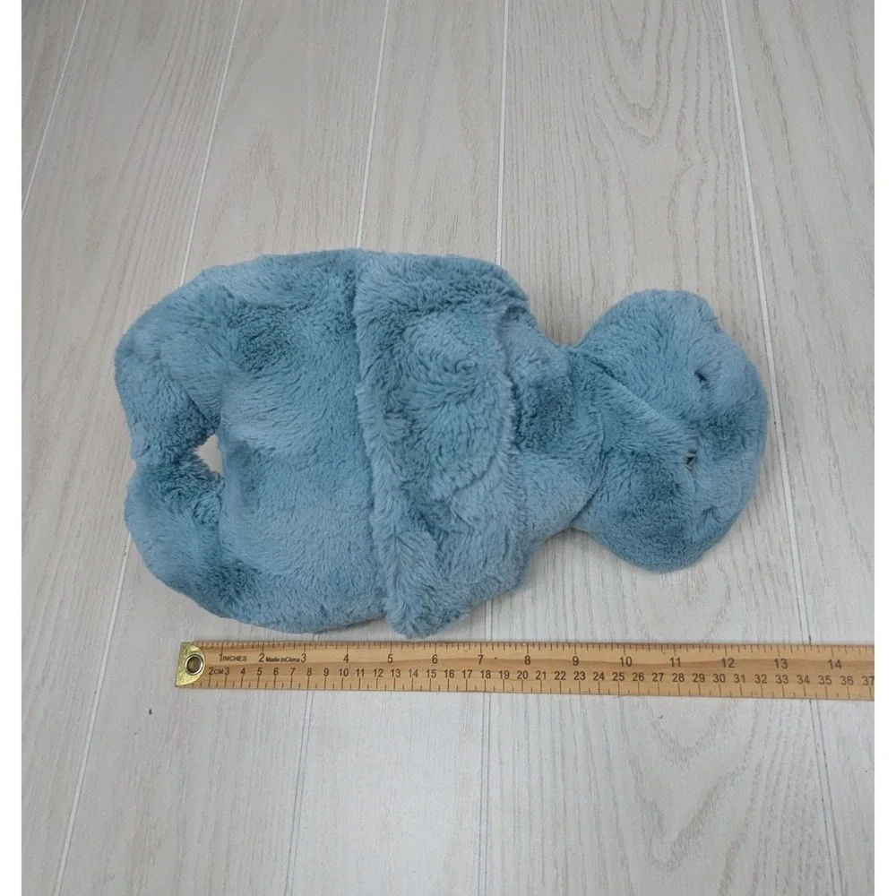 Mystery plush hugging arms Teal blue-green alien monster turtle Pom Bunny Tail